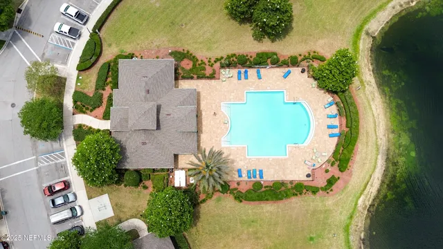 an aerial view of a house with a yard and lake view