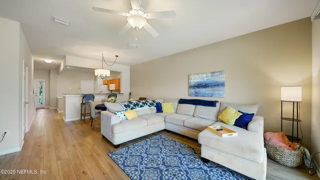 a living room with furniture and a chandelier