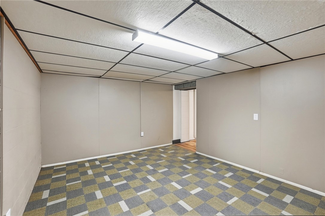 1628 Yorkshire Court Springfield, OH 45503 - Photo 37 of 47 This versatile basement space offers ample room for various uses, featuring durable carpet flooring.