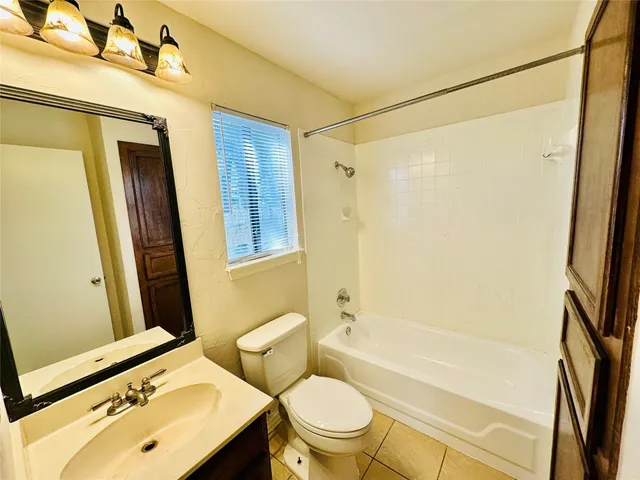 a bathroom with a sink mirror toilet and bathtub