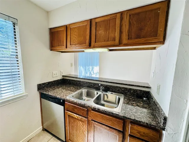 a close view of a sink a microwave and cabinets