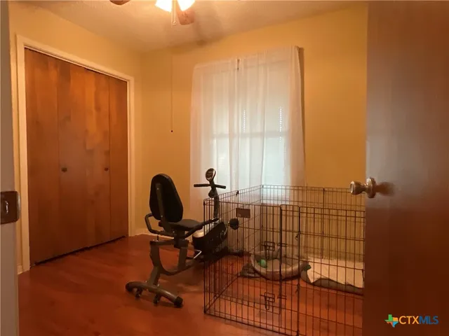 a view of workspace with wooden floor windows