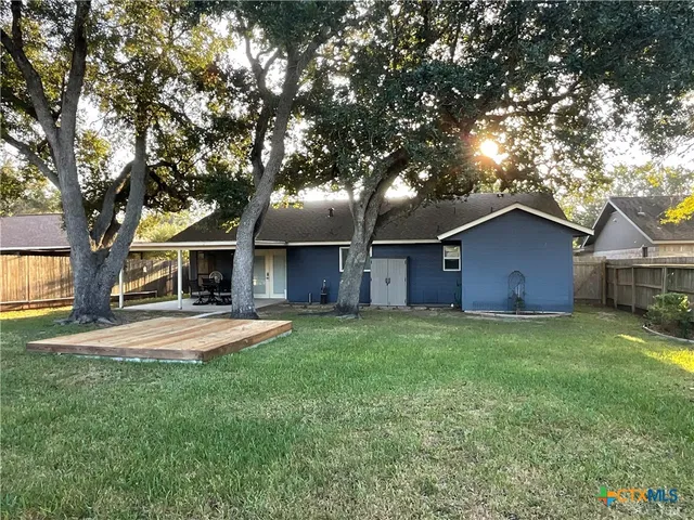 a front view of house with yard and trees
