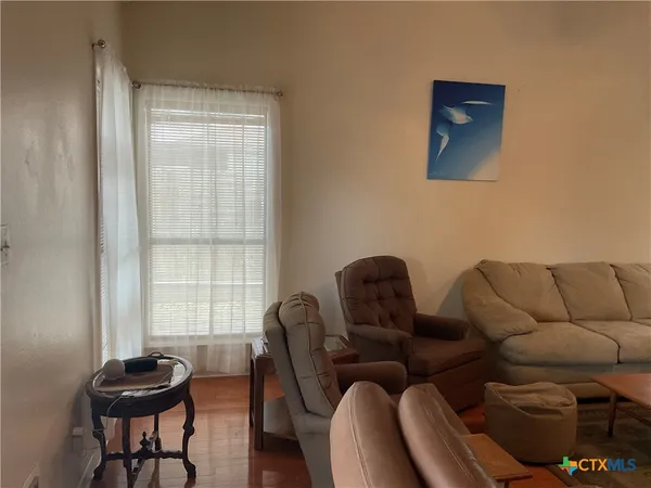 a view of a livingroom with furniture and a window