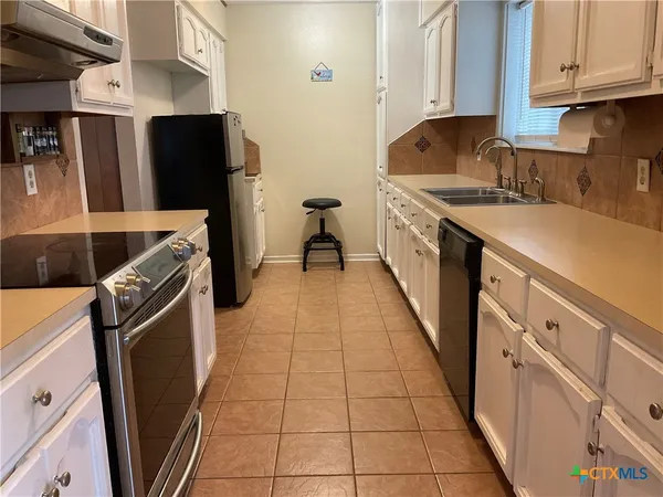 a kitchen with stainless steel appliances a refrigerator and a stove