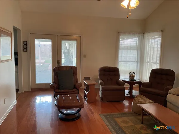 a living room with furniture and wooden floor