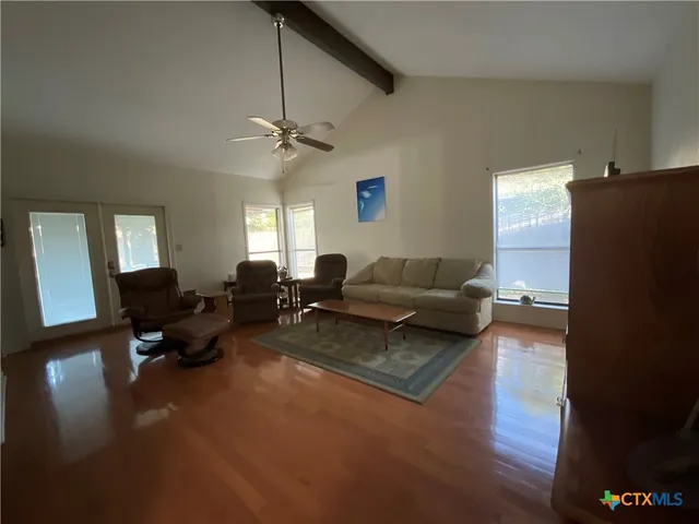 a living room with furniture and a chandelier