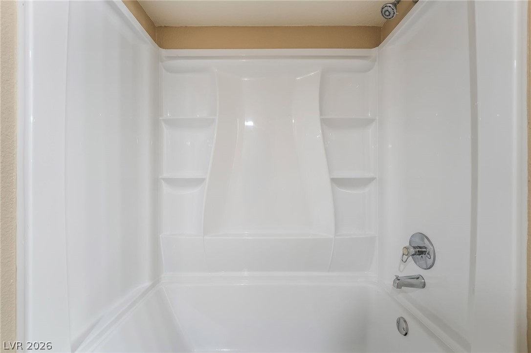 8070 West Russell Road, Unit 2024 Las Vegas, NV 89113 - Photo 13 of 19 A pristine bathtub and shower combination offers a relaxing oasis for unwinding after a long day.