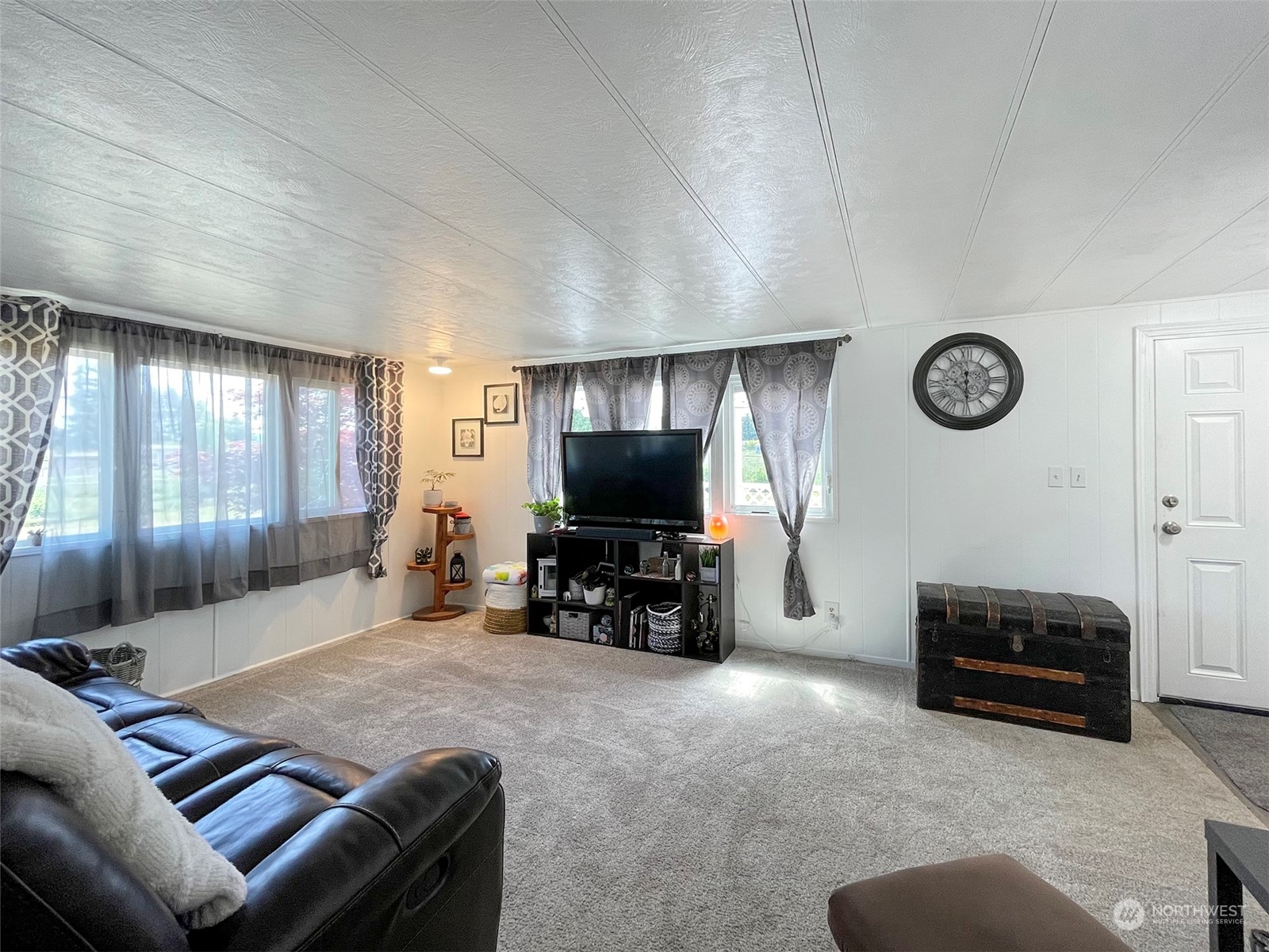 277 House Road Sequim, WA 98382 - Photo 16 of 40 a living room with furniture and a flat screen tv