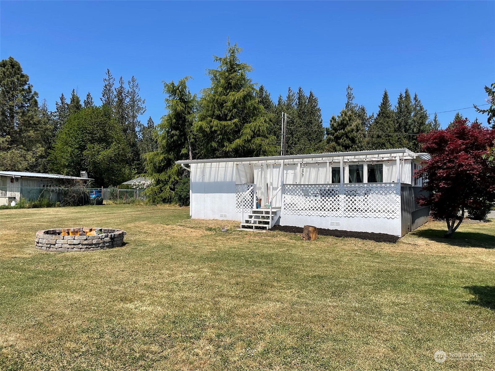 277 House Road Sequim, WA 98382 - Photo 33 of 40 a view of a house with backyard and sitting area