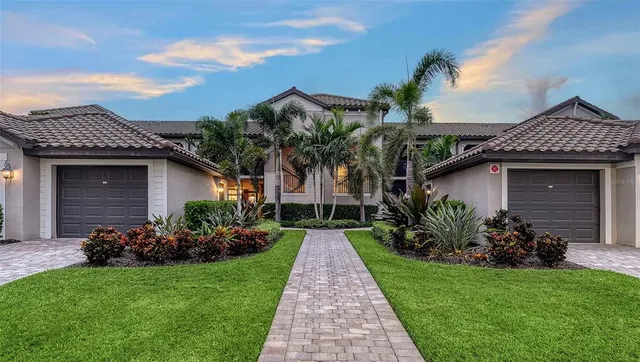 a front view of a house with a garden