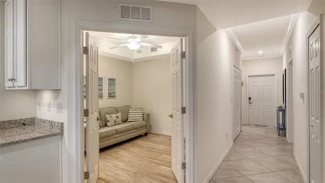 a living room with stainless steel appliances granite countertop couches a coffee table and chairs