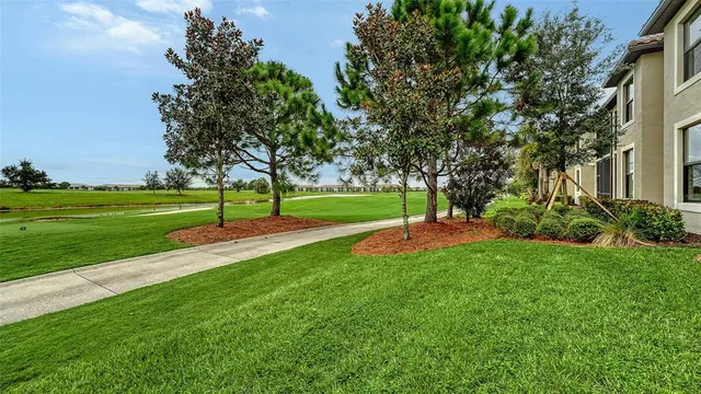 a swimming pool with outdoor seating and yard