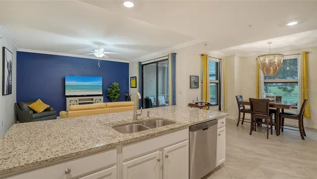 a living room with stainless steel appliances kitchen island granite countertop furniture and a view of kitchen