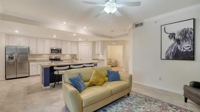 a dining room with furniture a chandelier and outdoor view
