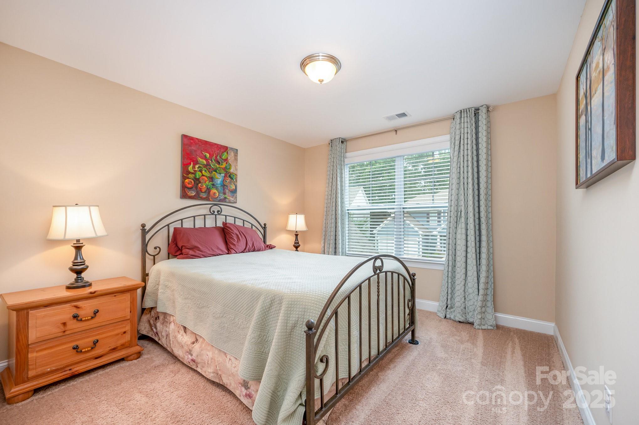 819 Coralbell Way Tega Cay, SC 29708 - Photo 20 of 33 a bedroom with a bed and a window