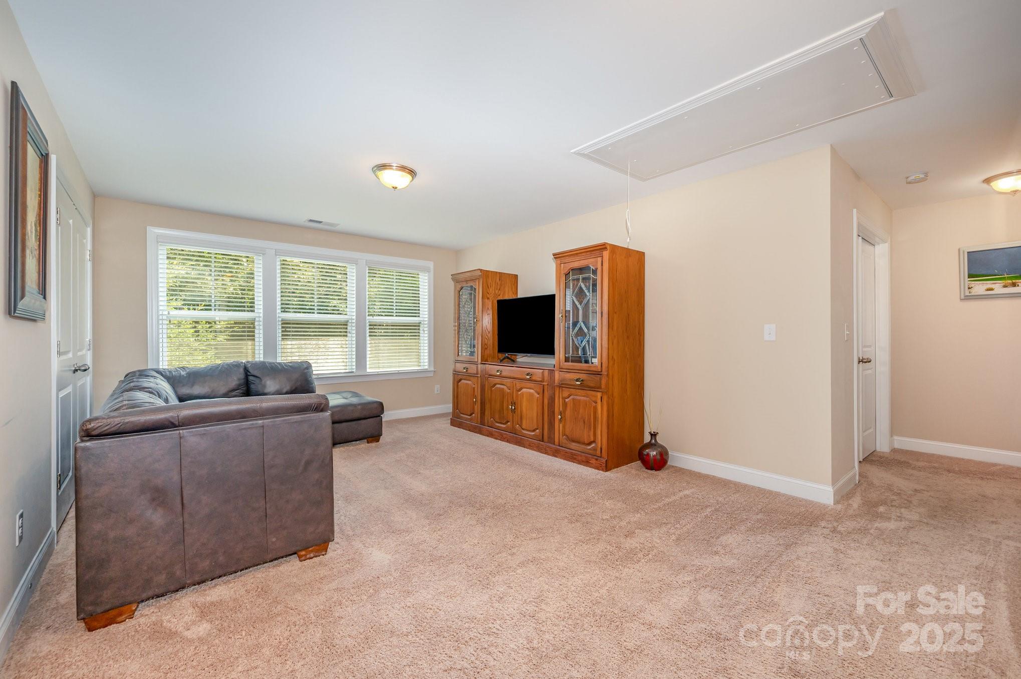 819 Coralbell Way Tega Cay, SC 29708 - Photo 22 of 33 a living room with furniture and a flat screen tv
