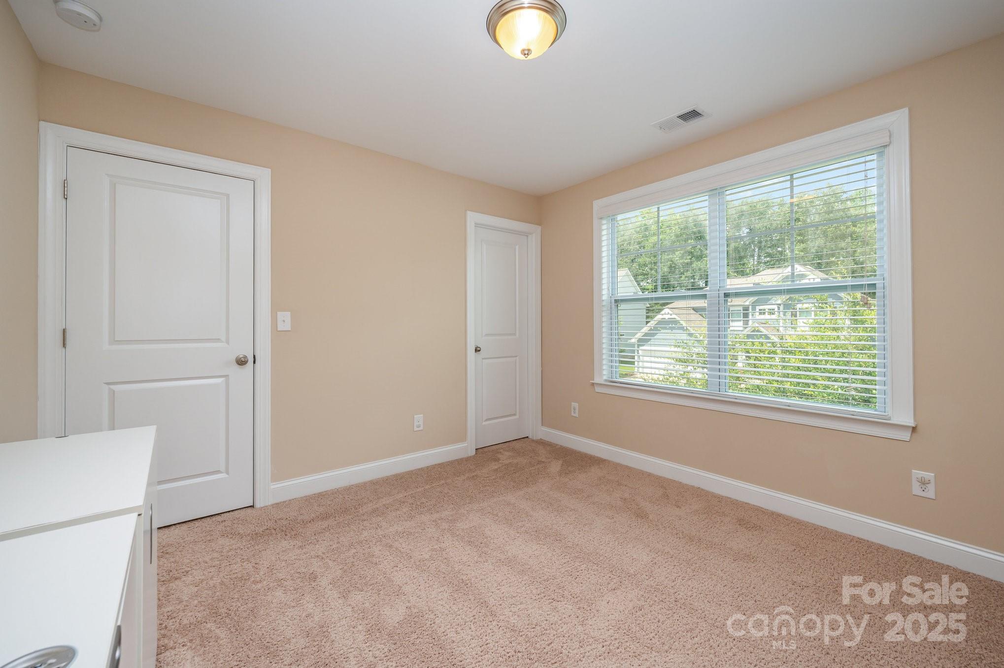 819 Coralbell Way Tega Cay, SC 29708 - Photo 23 of 33 a view of an empty room with a window and a bathroom