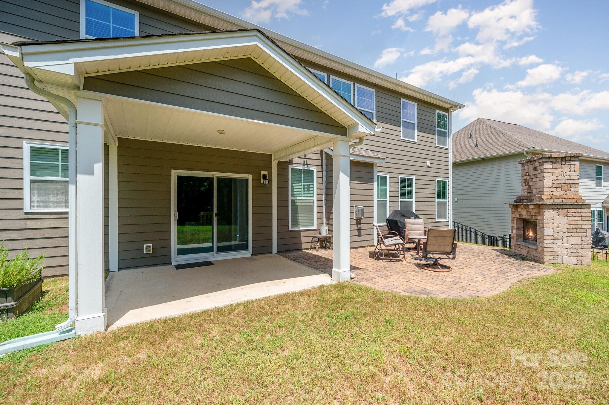 819 Coralbell Way Tega Cay, SC 29708 - Photo 26 of 33 a view of a house with backyard porch and sitting area