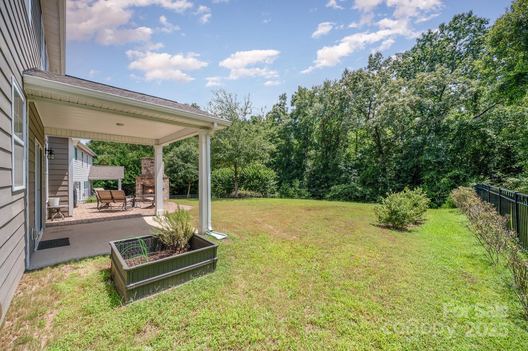 819 Coralbell Way Tega Cay, SC 29708 - Photo 27 of 33 a swimming pool with outdoor seating and yard