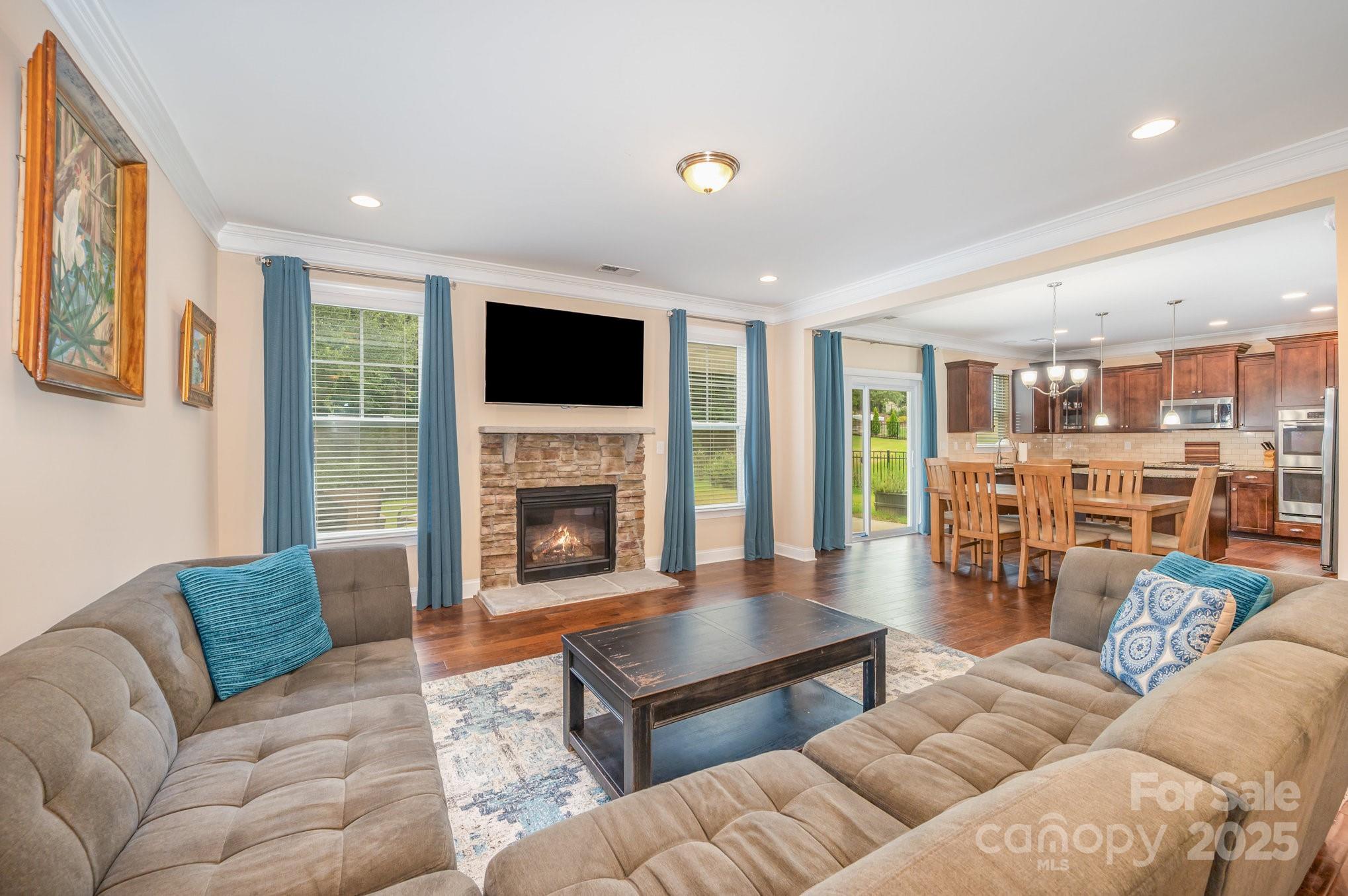 819 Coralbell Way Tega Cay, SC 29708 - Photo 3 of 33 a living room with furniture fireplace and a flat screen tv
