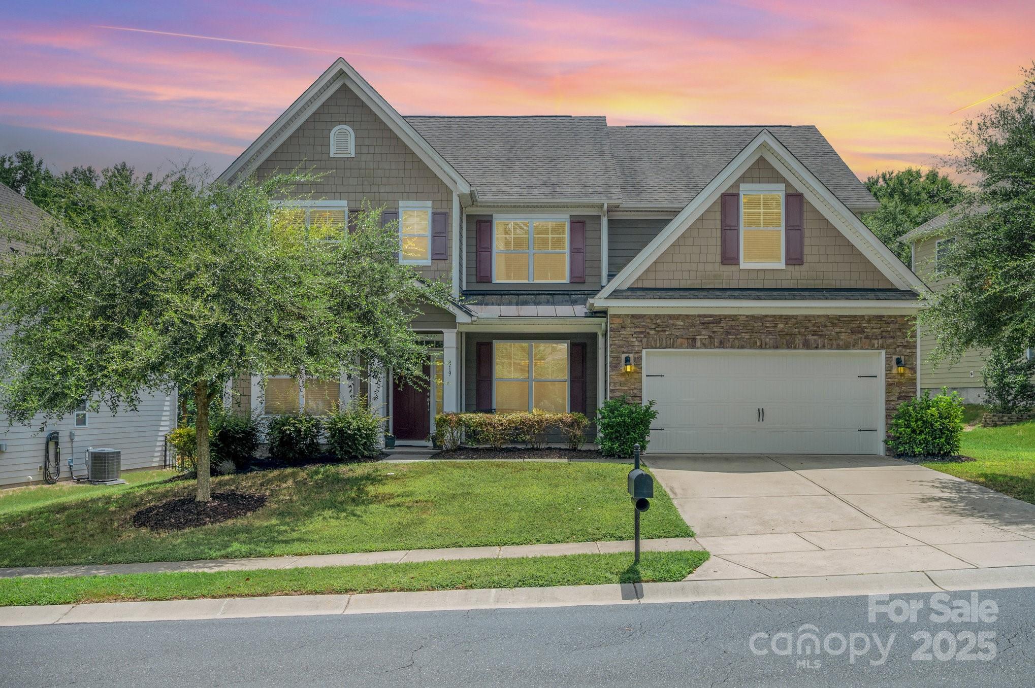 819 Coralbell Way Tega Cay, SC 29708 - Photo 33 of 33 a front view of a house with a yard and garage