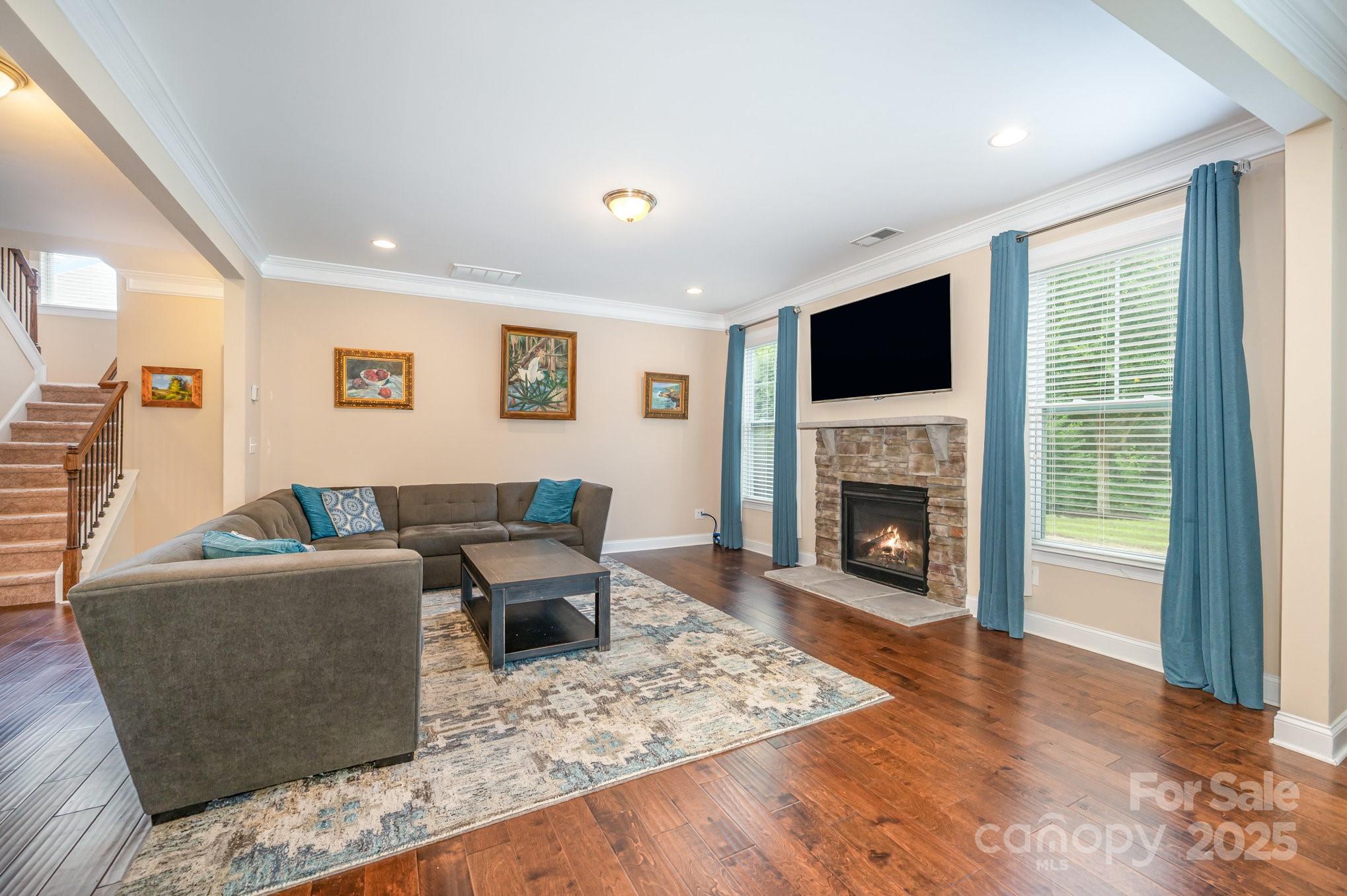 819 Coralbell Way Tega Cay, SC 29708 - Photo 4 of 33 a living room with furniture a fireplace and a flat screen tv