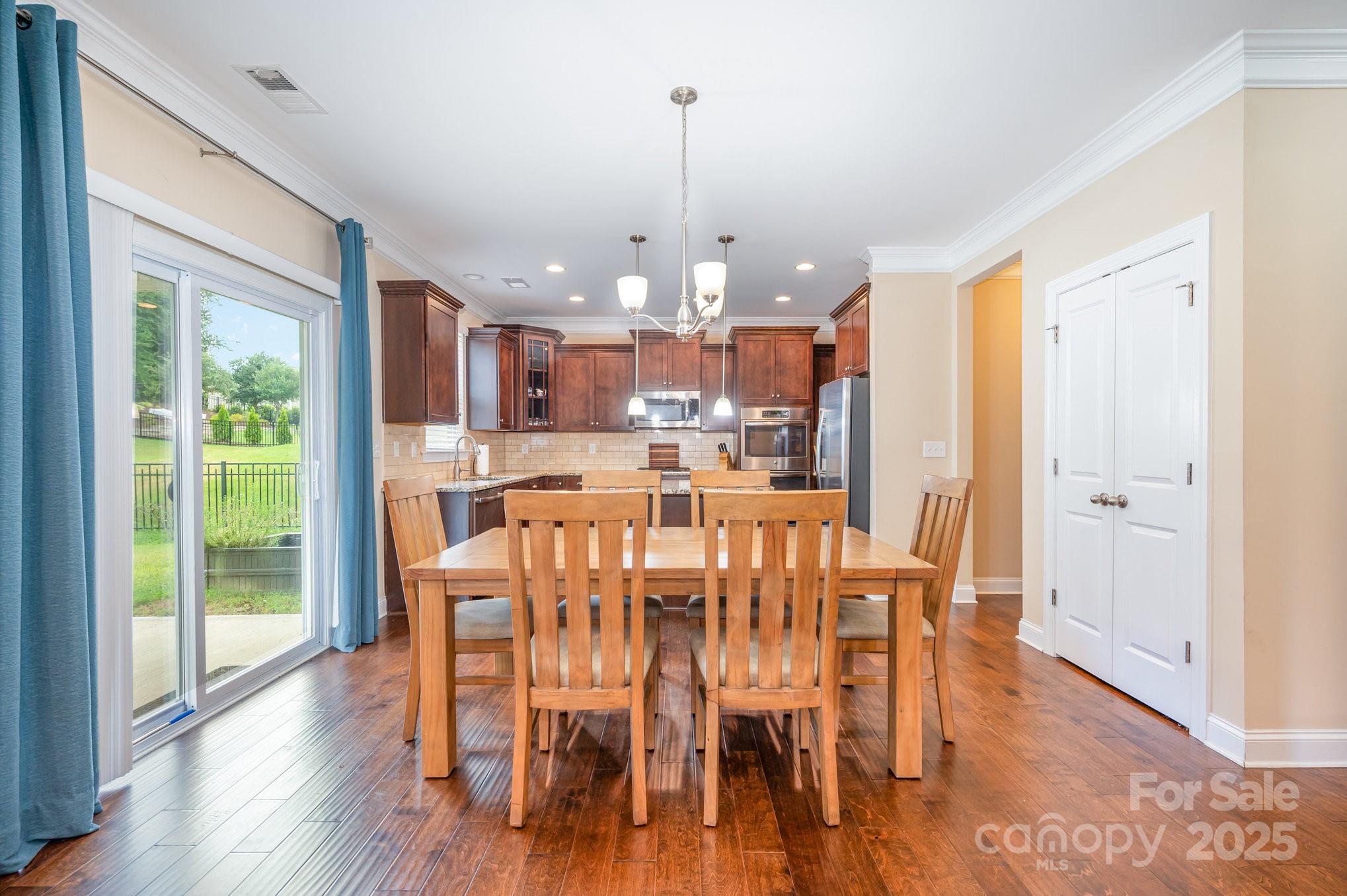 819 Coralbell Way Tega Cay, SC 29708 - Photo 8 of 33 a view of a dining room with furniture window and wooden floor