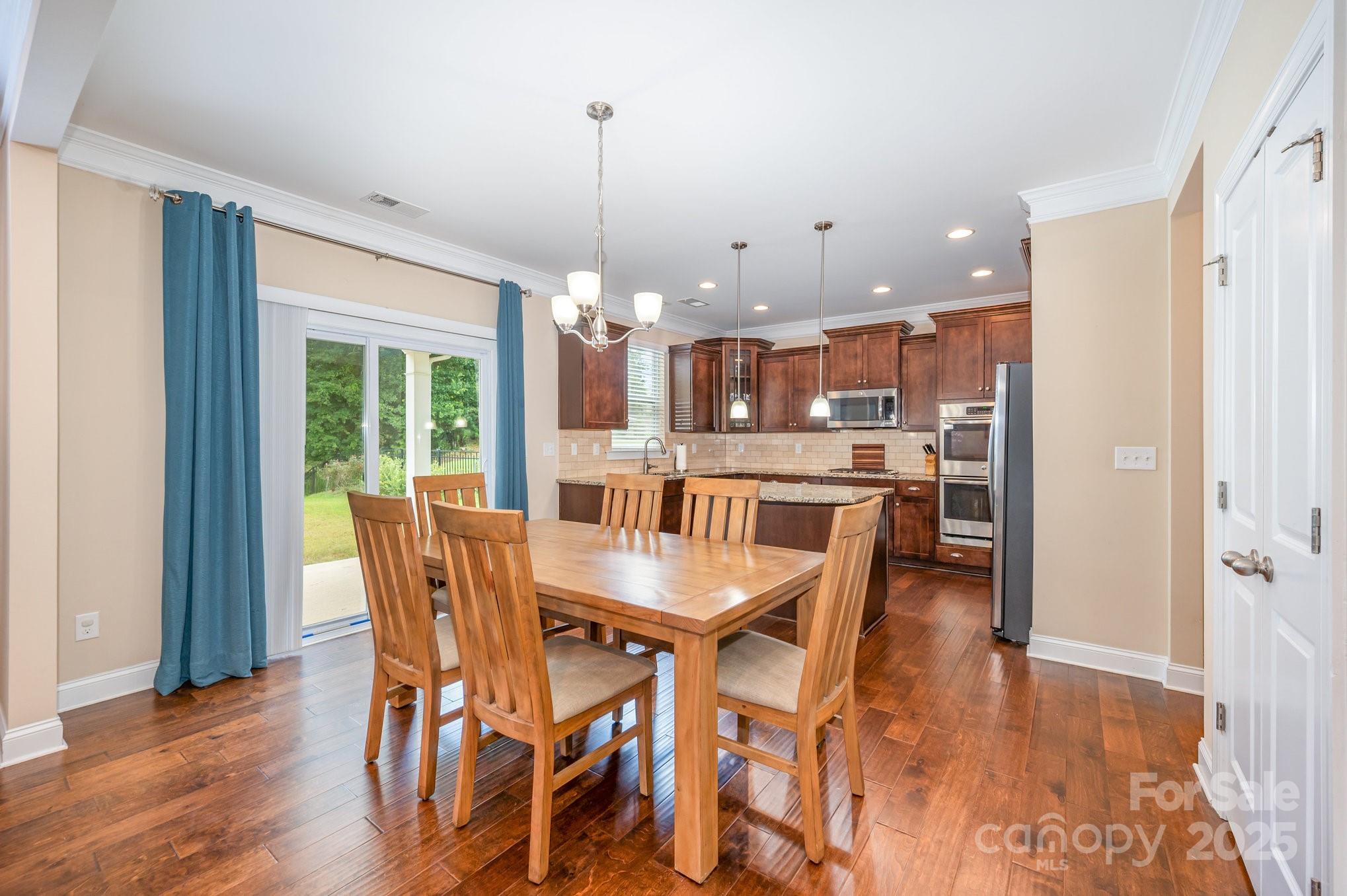 819 Coralbell Way Tega Cay, SC 29708 - Photo 9 of 33 a dining room with furniture and wooden floor