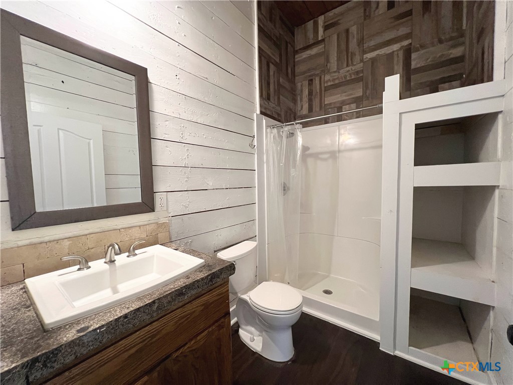 111 North 5th Street Temple, TX 76501 - Photo 12 of 19 a bathroom with a granite countertop sink toilet and shower