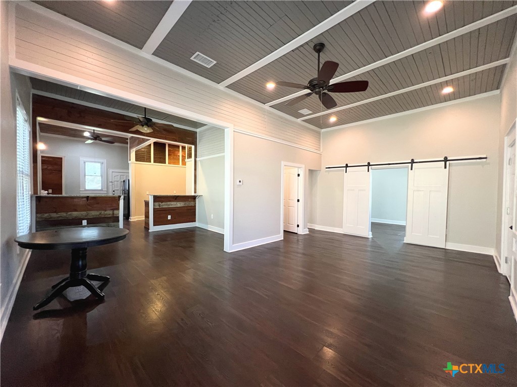 111 North 5th Street Temple, TX 76501 - Photo 3 of 19 a view of a livingroom with wooden floor a ceiling fan and a window