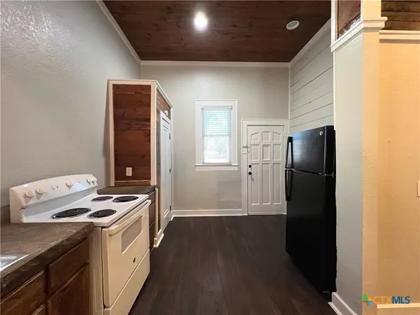a kitchen with stainless steel appliances granite countertop a stove and a refrigerator