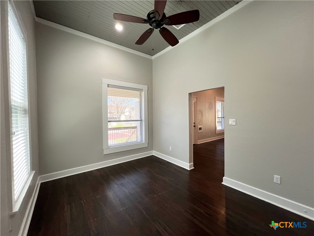 111 North 5th Street Temple, TX 76501 - Photo 10 of 19 an empty room with wooden floor and windows