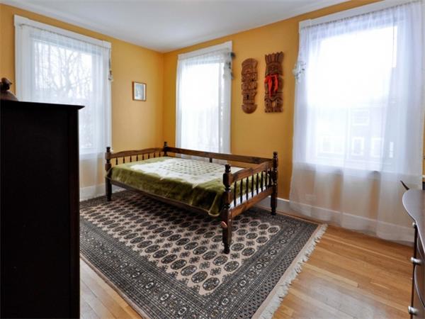 239 Walnut Street, Unit 239 Wellesley, MA 02481 - Photo 12 of 19 a bedroom with a bed and wooden floor