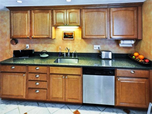 239 Walnut Street, Unit 239 Wellesley, MA 02481 - Photo 4 of 19 a kitchen with stainless steel appliances granite countertop wooden cabinets and a a sink