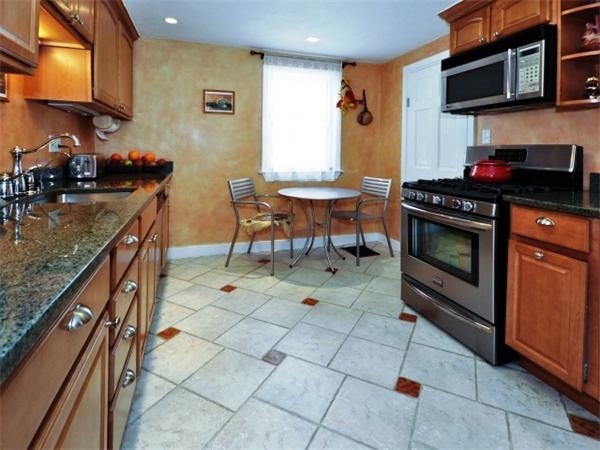 239 Walnut Street, Unit 239 Wellesley, MA 02481 - Photo 5 of 19 a kitchen with stainless steel appliances granite countertop a stove a sink and a microwave