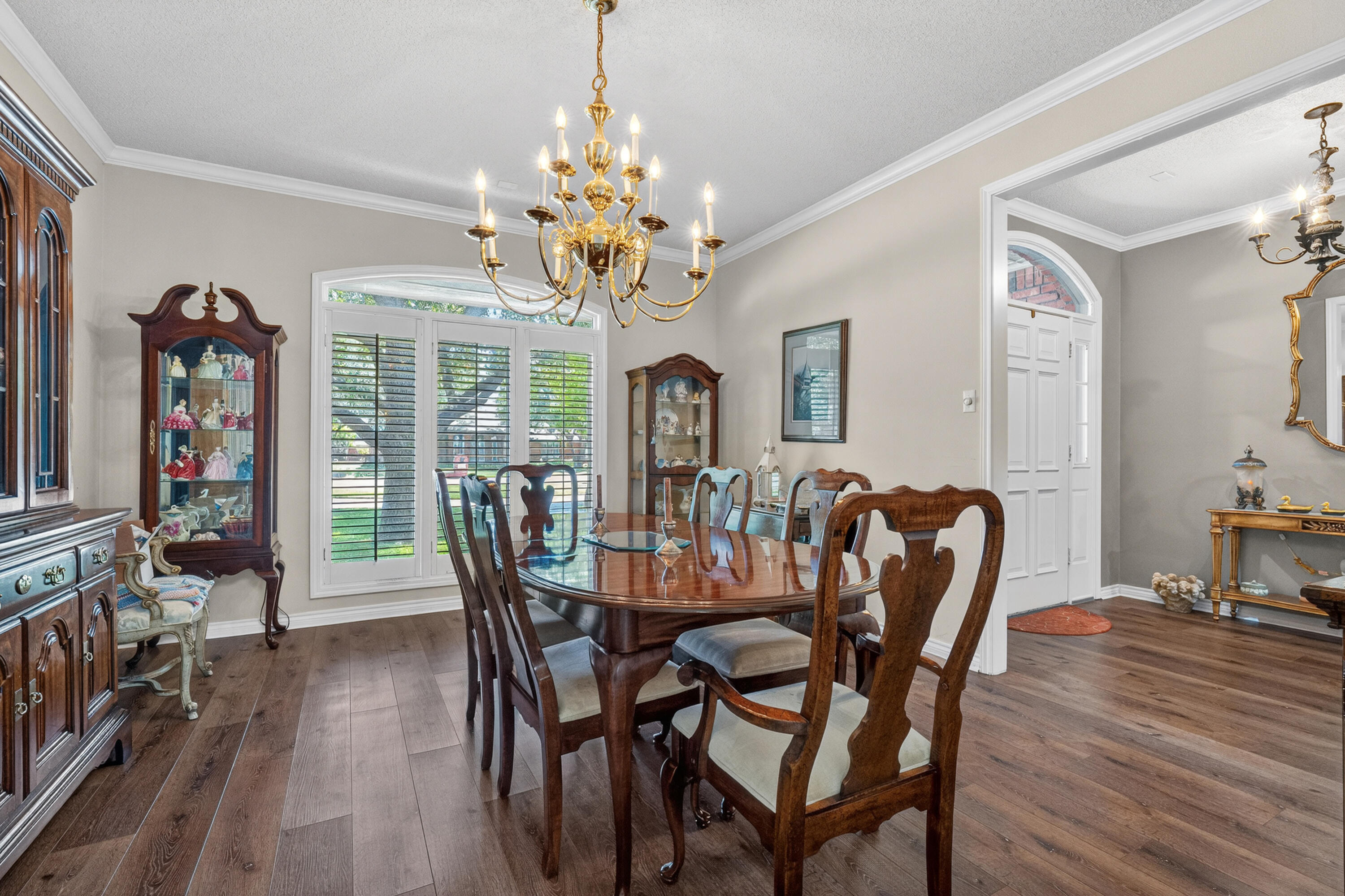 7402 95th Street Lubbock, TX 79424 - Photo 12 of 43 a view of a dining room with furniture wooden floor and chandelier
