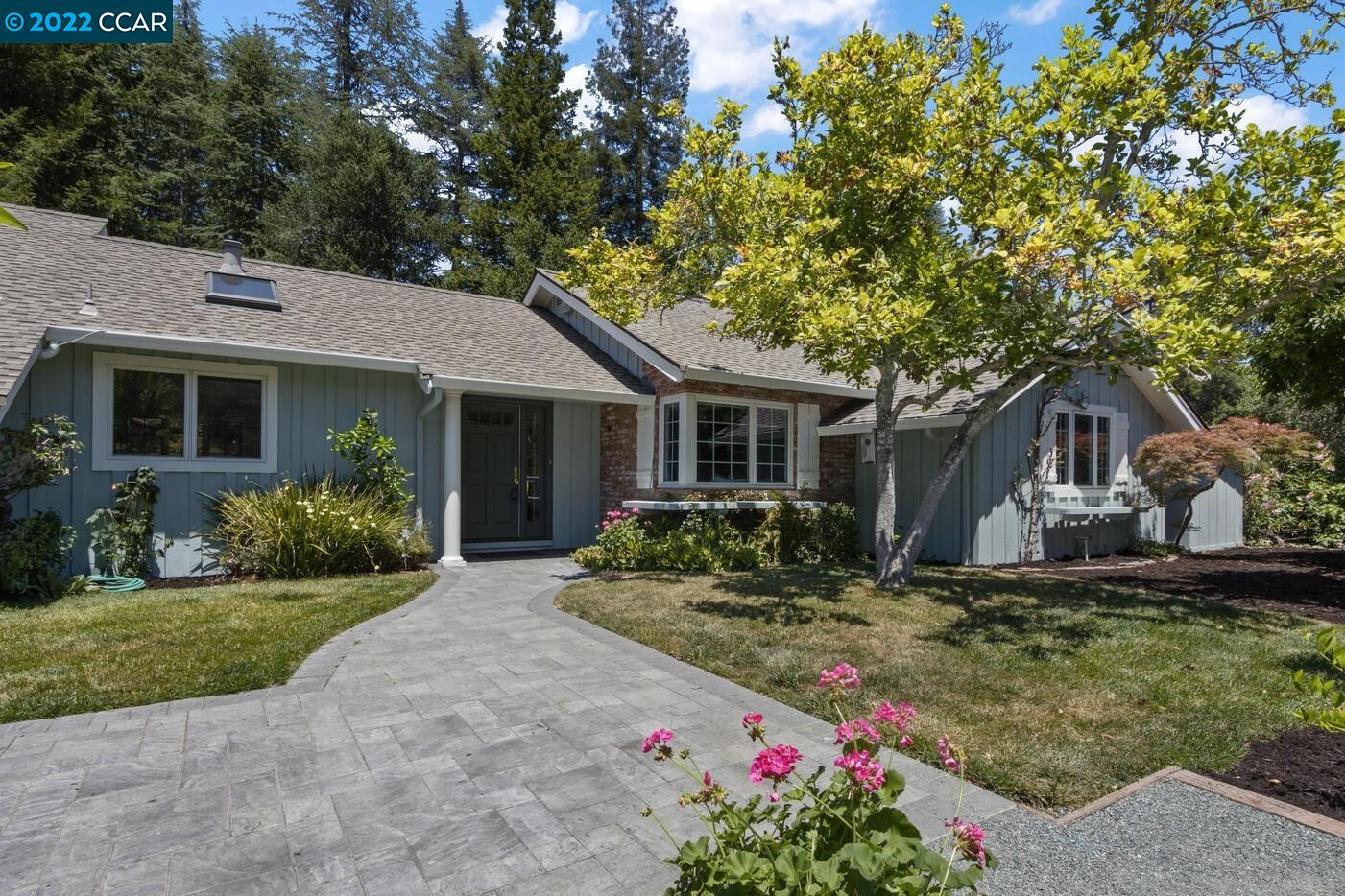 a front view of house with yard and green space