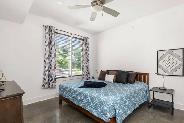 a bedroom with a bed and window