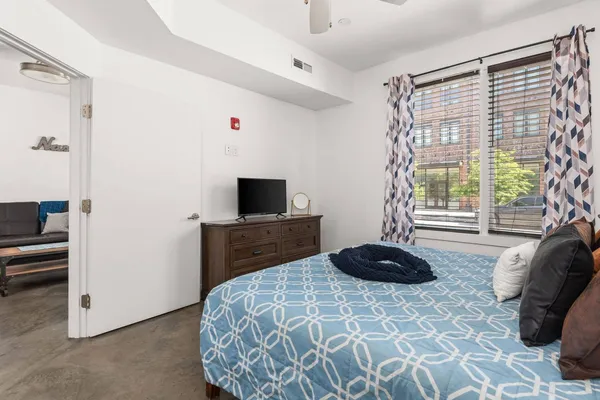 a bedroom with a bed and a window