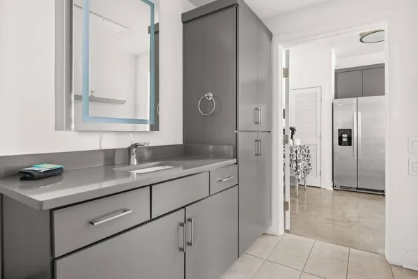 a bathroom with a granite countertop sink and a mirror