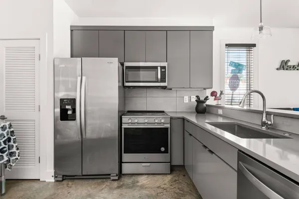 a kitchen with a sink and a refrigerator