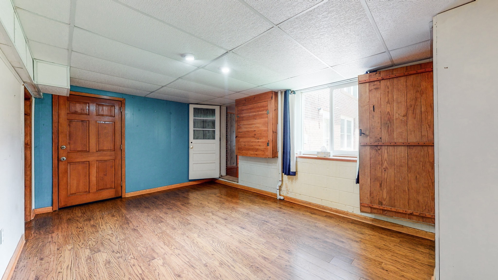 2101 Pea Ridge Road Clarksville, TN 37040 - Photo 33 of 59 an empty room with wooden floor and windows with curtains