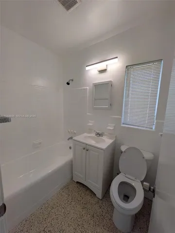 a bathroom with a sink a toilet and bathtub