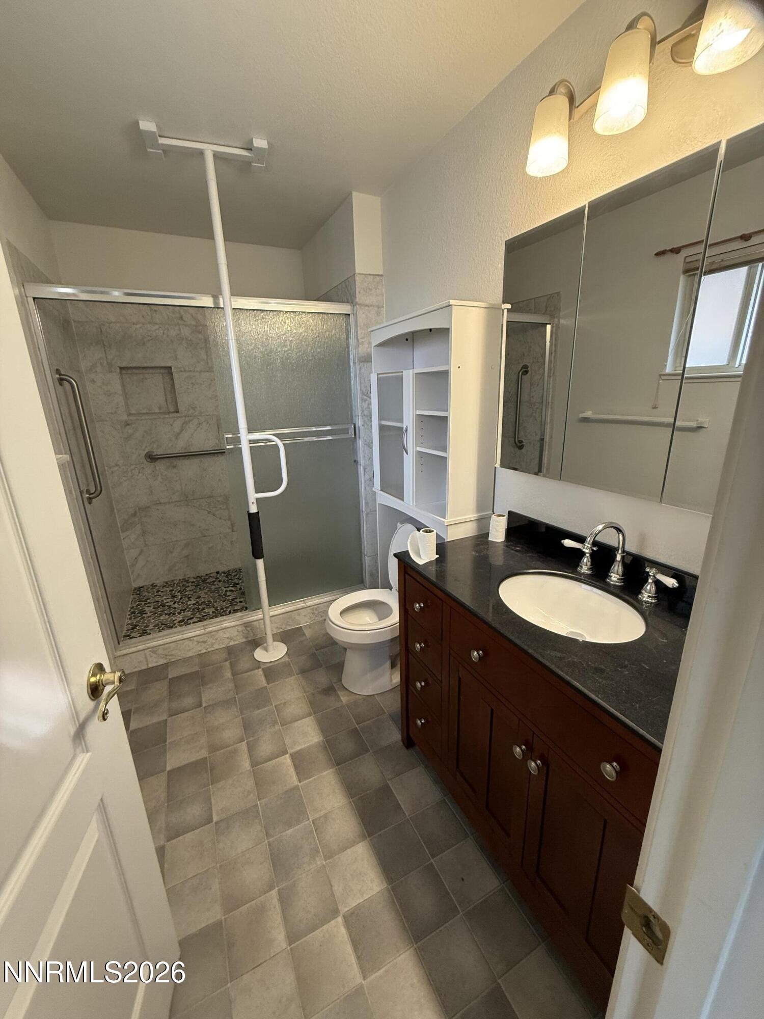 285 Amanda Lane Fallon, NV 89406 - Photo 11 of 15 a bathroom with a sink a toilet a mirror and shower