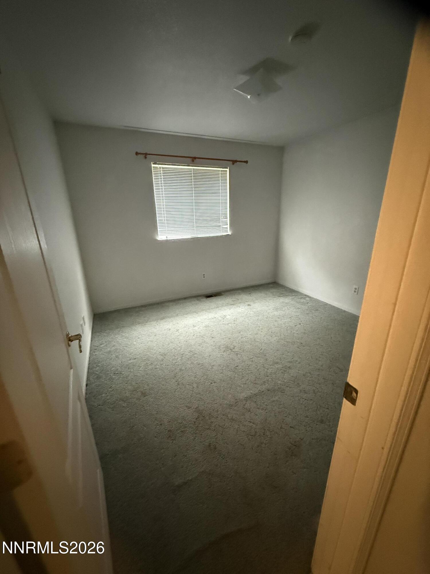 285 Amanda Lane Fallon, NV 89406 - Photo 12 of 15 an empty room with a wooden door