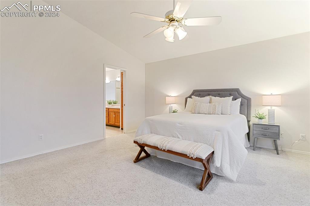 12595 Mc Cune Road Elbert, CO 80106 - Photo 23 of 50 a bedroom with a bed and a chandelier