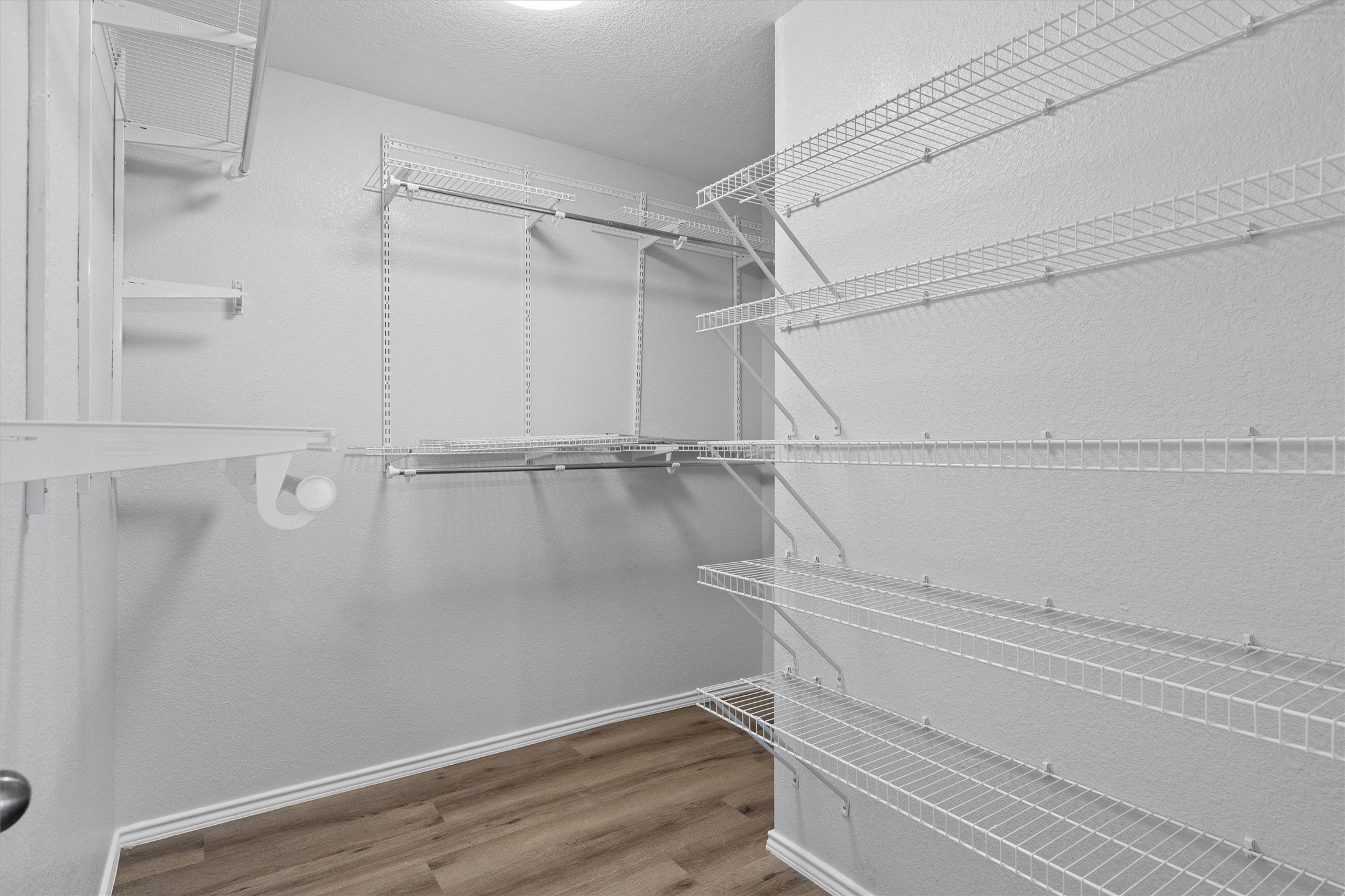 1833 Thompson Trail Round Rock, TX 78664 - Photo 22 of 40 Streamlined wire shelving and hanging rods organize this naturally lit walk-in closet.