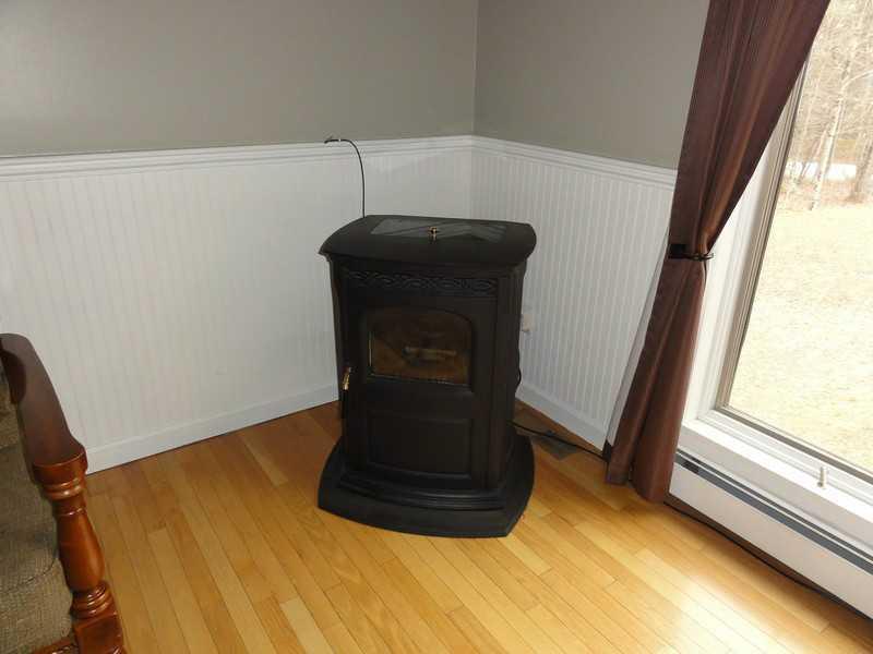 148 Point Road Belgrade, ME 04917 - Photo 20 of 27 Living Room. Pellet stove.