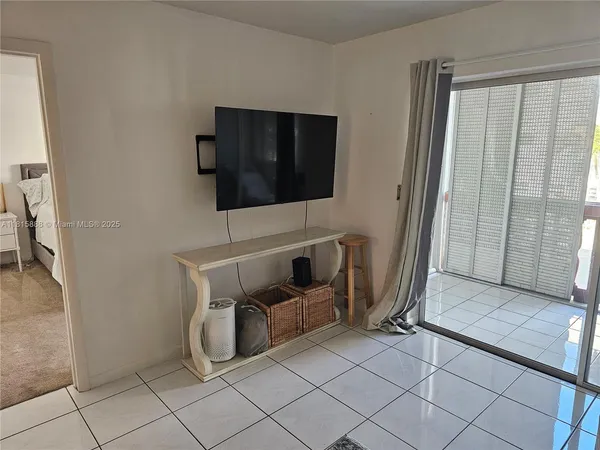 a living room with furniture and a dining table